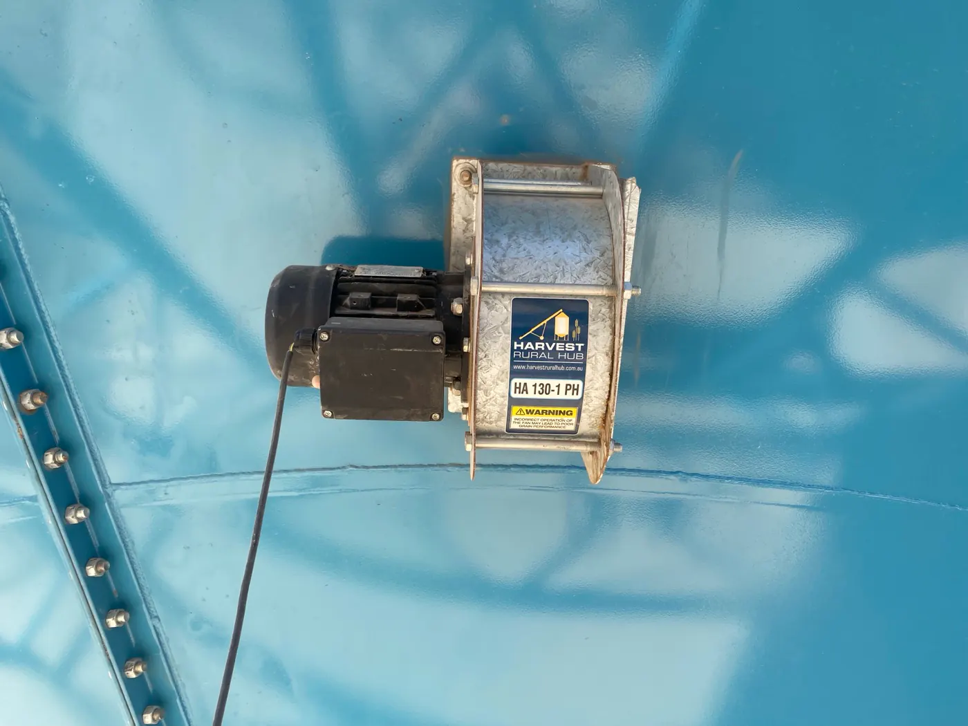 Silo aeration fan at the base of a grain silo