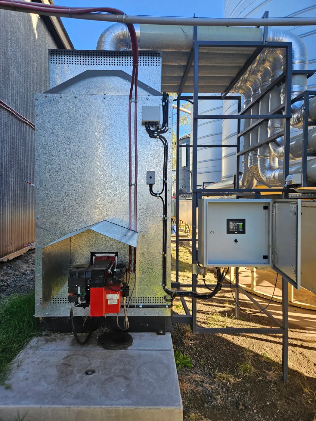 Aeration fan and fume box beside a silo